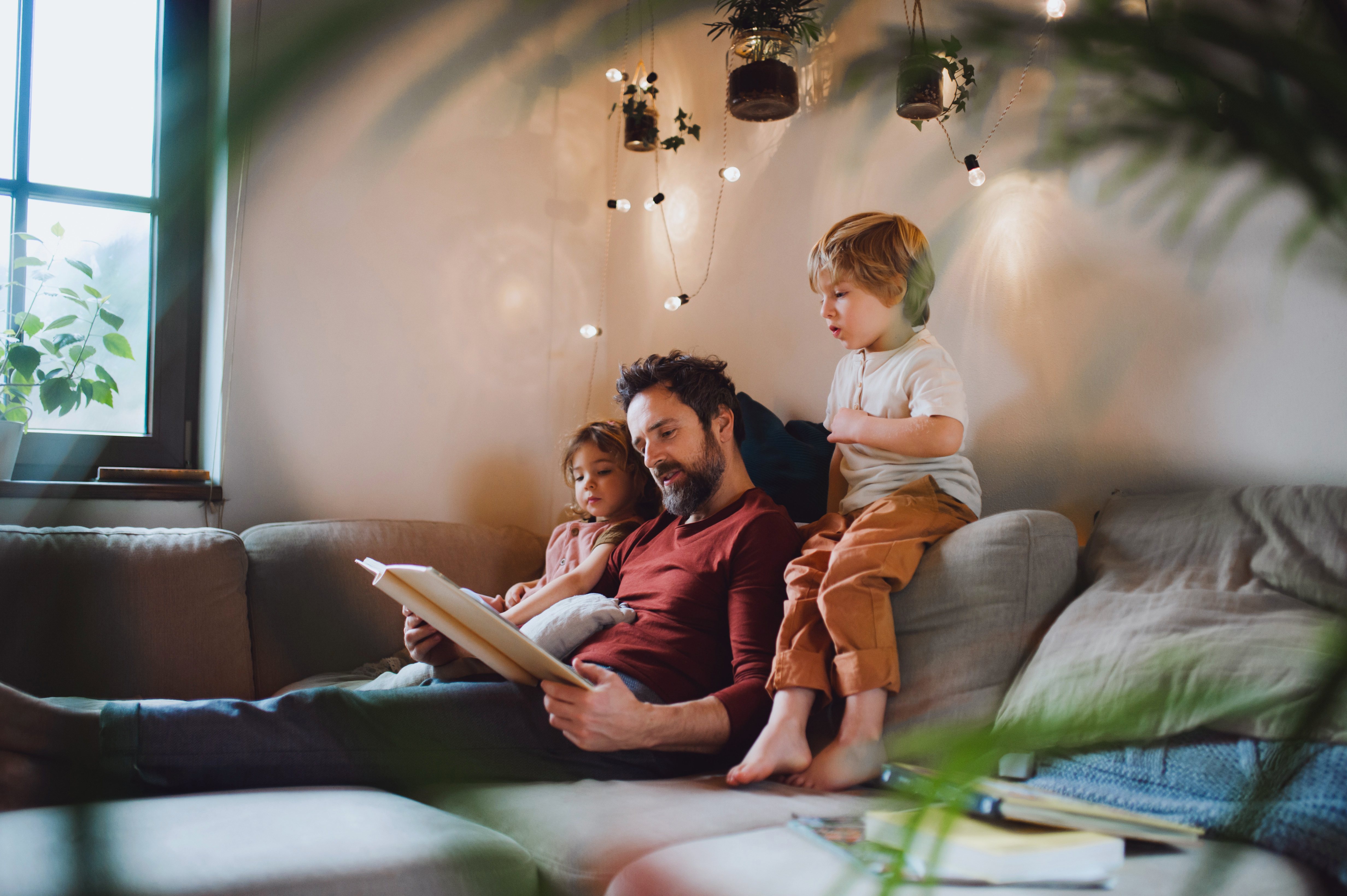 Father reading with children on the couch